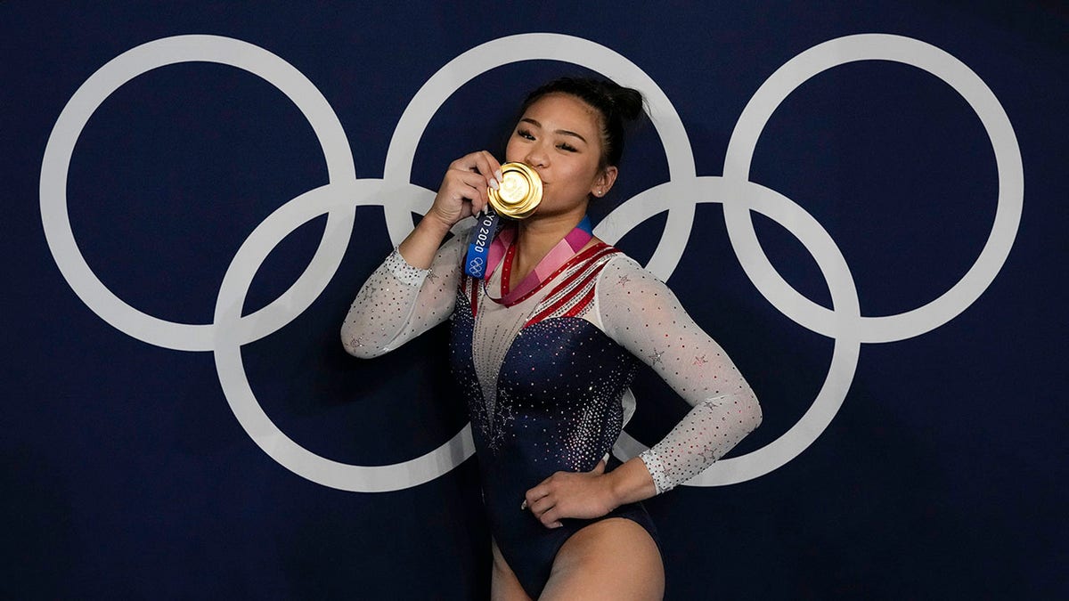 Sunisa Lee poses with the gold medal