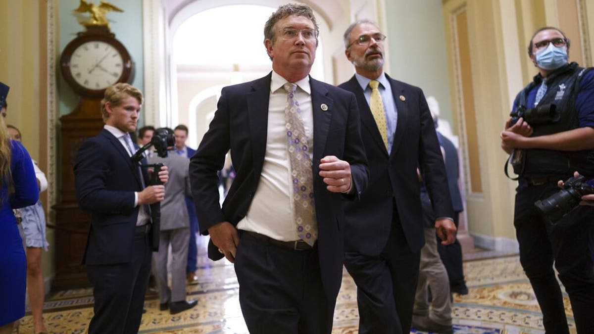 Rep. Thomas Massie, R-Ky., left, Rep. Andy Harris, R-Md., and other conservative members of the House walk to the Senate chamber, as they express their opposition to new mask guidance, at the Capitol in Washington, Thursday, July 29, 2021. Earlier in the day, House Minority Leader Kevin McCarthy, R-Calif., charged that the Centers for Disease Control has become a political arm of the administration. (AP Photo/J. Scott Applewhite)