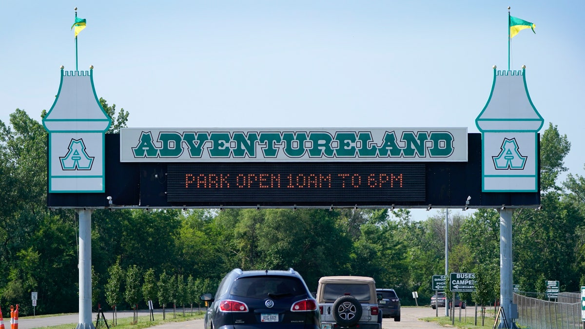 Visitors arrive at the Adventureland Park amusement park, Tuesday, July 6, 2021, in Altoona, Iowa. (AP Photo/Charlie Neibergall)