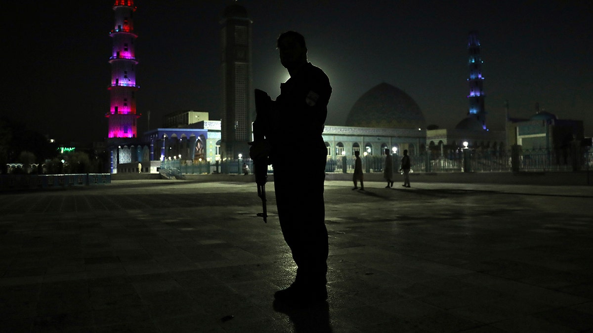 An Afghan security police officer stands guard in the courtyard of Hazrat-e-Ali shrine or Blue Mosque, in the city of Mazar-e-Sharif province north of Kabul, Afghanistan, Wednesday, July 7, 2021. (AP Photo/Rahmat Gul)