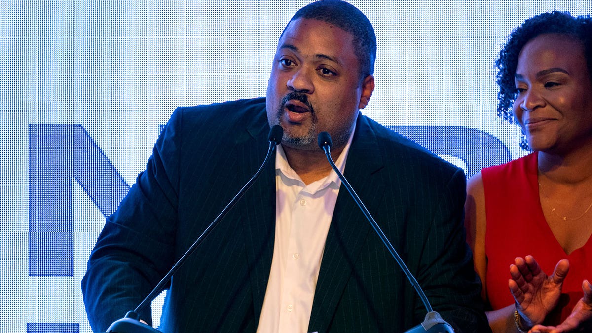 Alvin Bragg, a former top deputy to New York's attorney general, stands with his wife, Jamila Bragg, at an election night gathering as he speaks to supporters in New York, June 22, 2021.