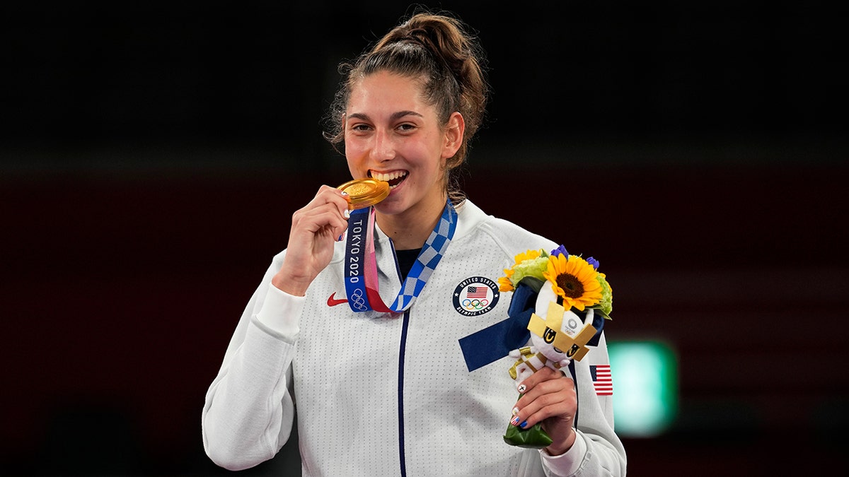 U.S. Olympian Anastasija Zolotic holds her gold medal during a ceremony for the taekwondo women's 57kg at the 2020 Summer Olympics