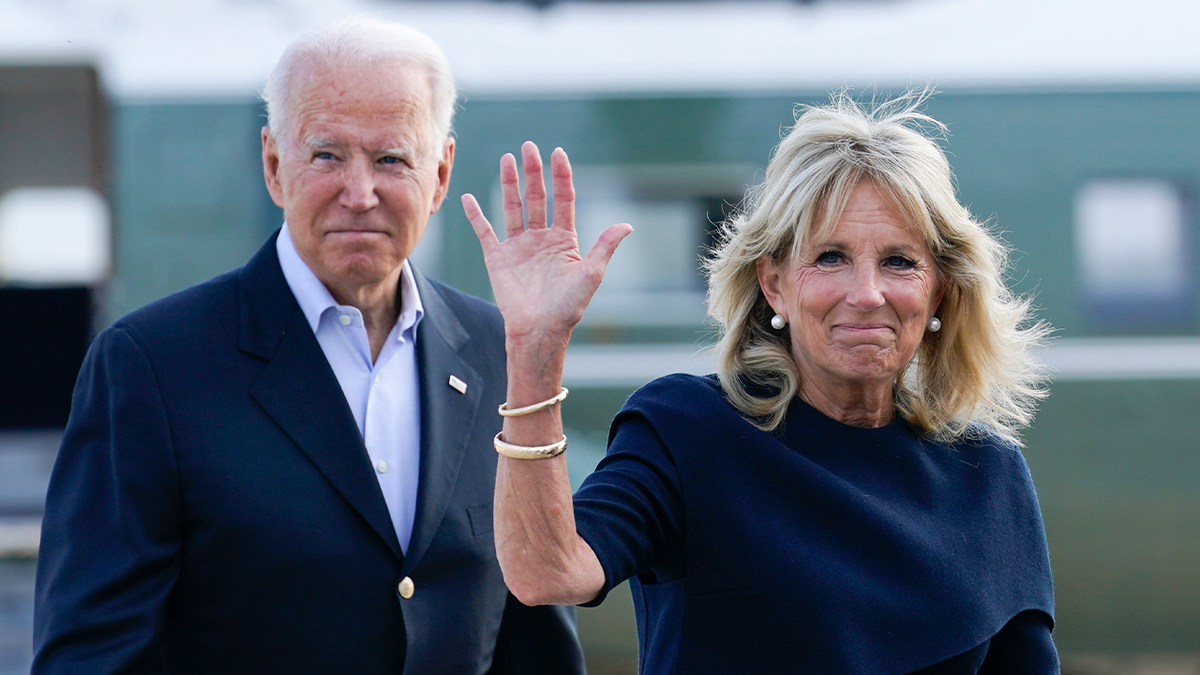 Jill Biden and Joe Biden wave to the press