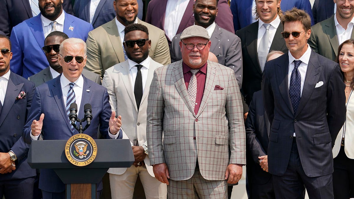 President Biden, surrounded by members of the Tampa Bay Buccaneers, speaks during a ceremony on the South Lawn of the White House in Washington, Tuesday, July 20, 2021, where the president honored the Super Bowl champion Tampa Bay Buccaneers for their Super Bowl LV victory. (AP Photo/Andrew Harnik)