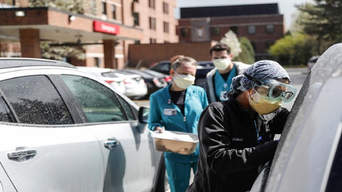 FILE - In this April 15, 2021, file photo, Emergency Room technicians test patients for Covid-19 outside of the emergency entrance of Beaumont Hospital in Grosse Pointe, Mich. Michigan.