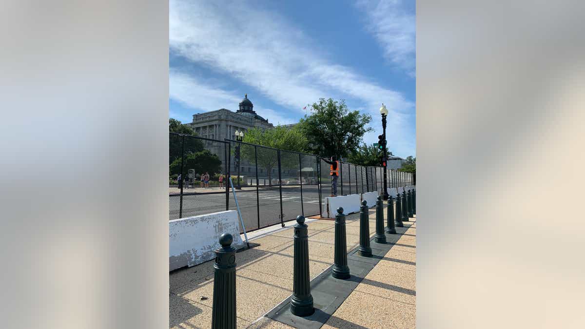 The main fence begins to come down. 