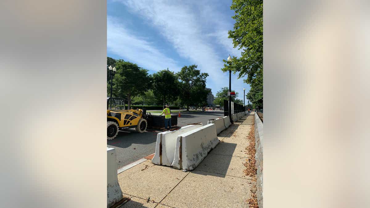 Crews are stacking the perimeter fence in piles and moving the concrete barriers that reinforced the fence. (Kelly Laco/Fox News)