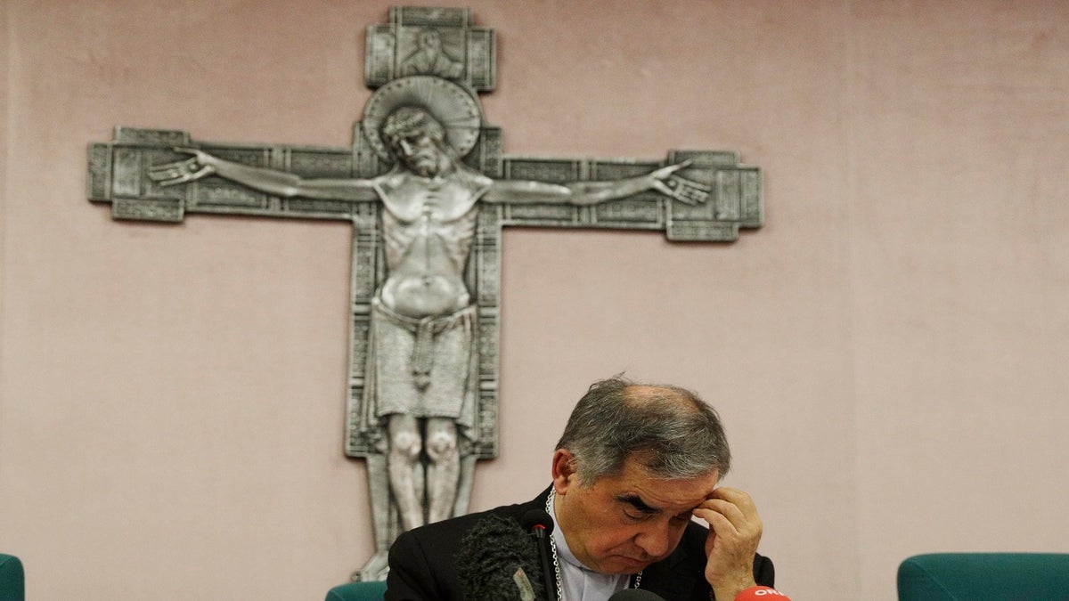 FILE - In this Friday, Sept. 25, 2020 file photo, Cardinal Angelo Becciu looks down as he meets the media during a press conference in Rome. (AP Photo/Gregorio Borgia, File)