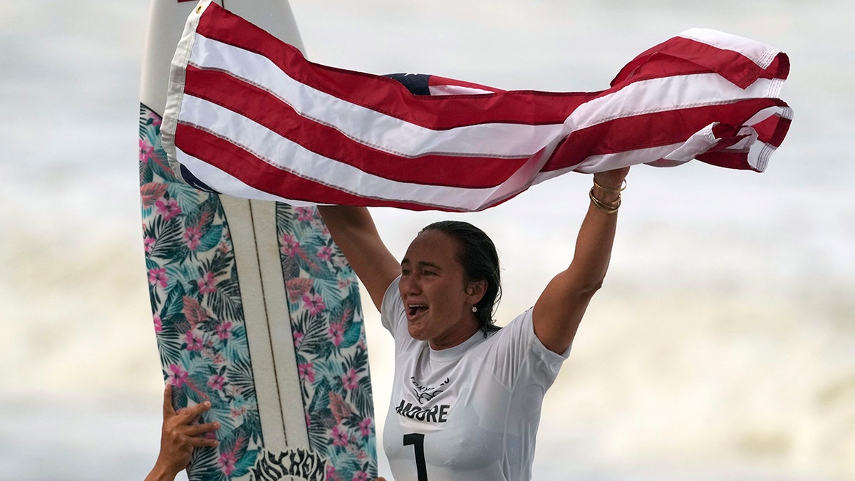 Carissa Moore, of the United States, celebrates winning the gold medal of the women's surfing competition at the 2020 Summer Olympic