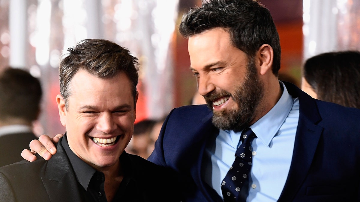 Matt Damon and Ben Affleck share a laugh on the red carpet.