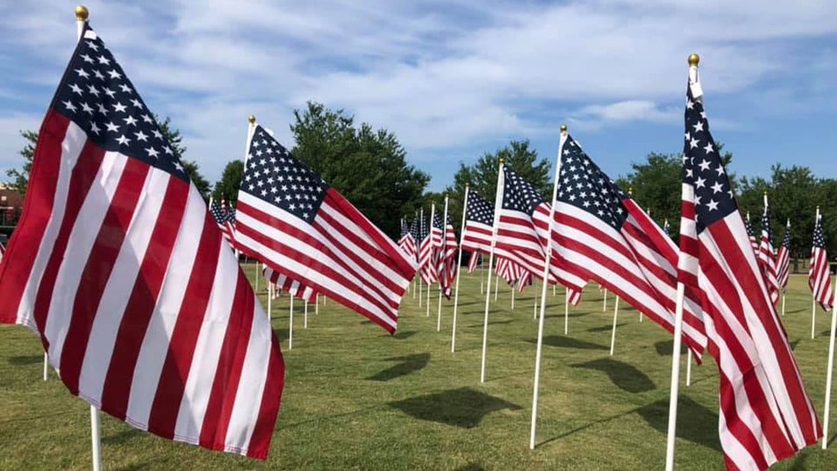 American flags are seen in field