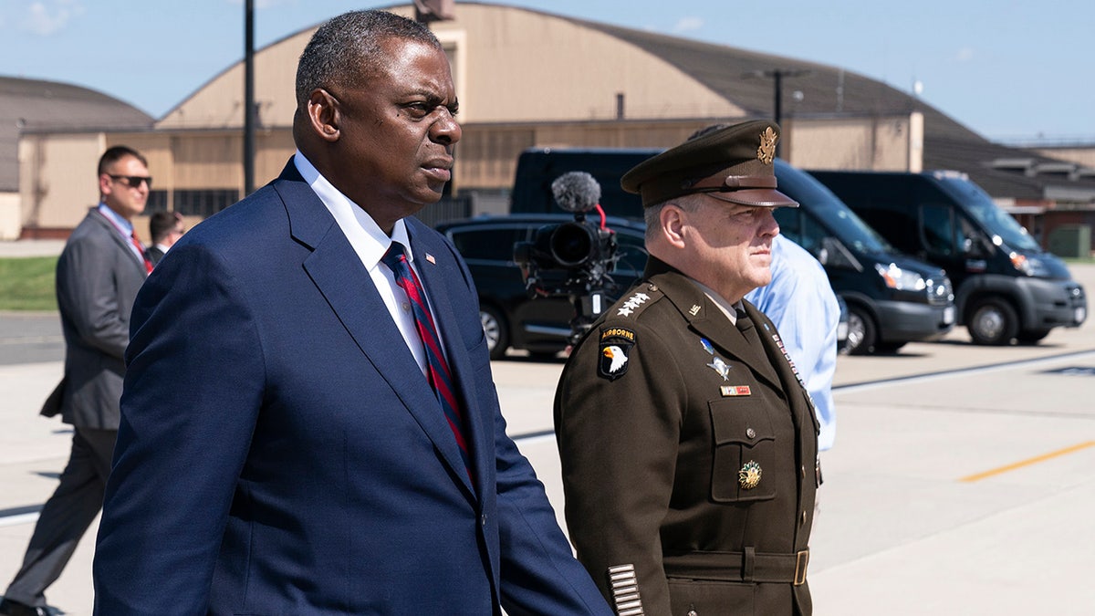 Secretary of Defense Lloyd Austin, left, and Joint Chiefs Chairman Gen. Mark Milley walk to greet U.S. Army Gen. Scott Miller, the former top U.S. commander in Afghanistan, upon his return Wednesday, July 14, 2021, at Andrews Air Force Base, Md. (AP Photo/Alex Brandon, Pool)