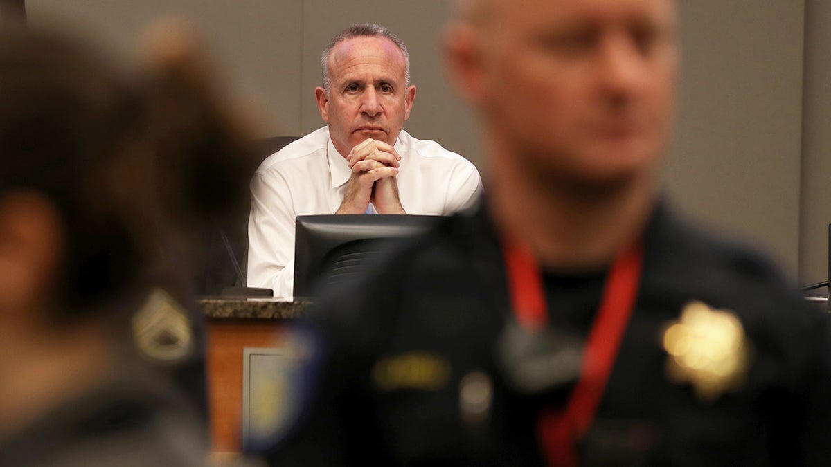 Sacramento Mayor Darrell Steinberg looks on as activists disrupt a Sacramento City Council meeting.