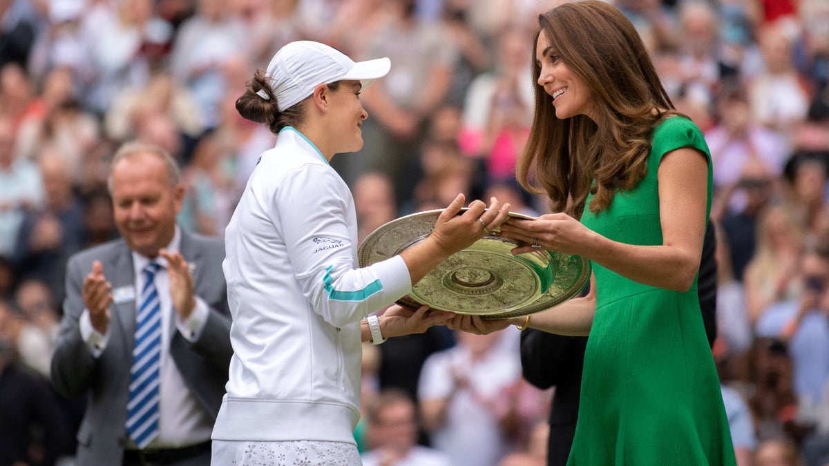 Australia's Ashleigh Barty receives the trophy from Britain's Catherine, Duchess of Cambridge, after defeating Czech Republic's Karolina Pliskova during their women's singles final match on the twelfth day of the 2021 Wimbledon Championships at The All England Tennis Club in Wimbledon, southwest London, on July 10, 2021. (Photo by AELTC/BEN SOLOMON/POOL/AFP via Getty Images)