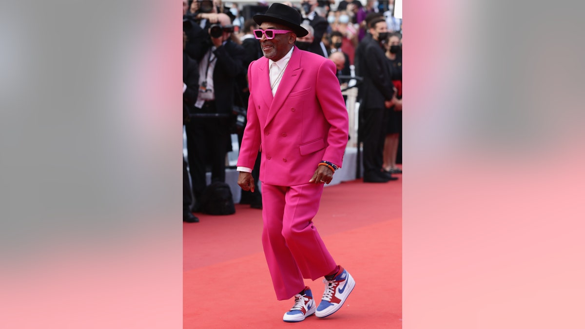 Jury president and director Spike Lee hits the carpet in a bright pink suit and sneakers. 
