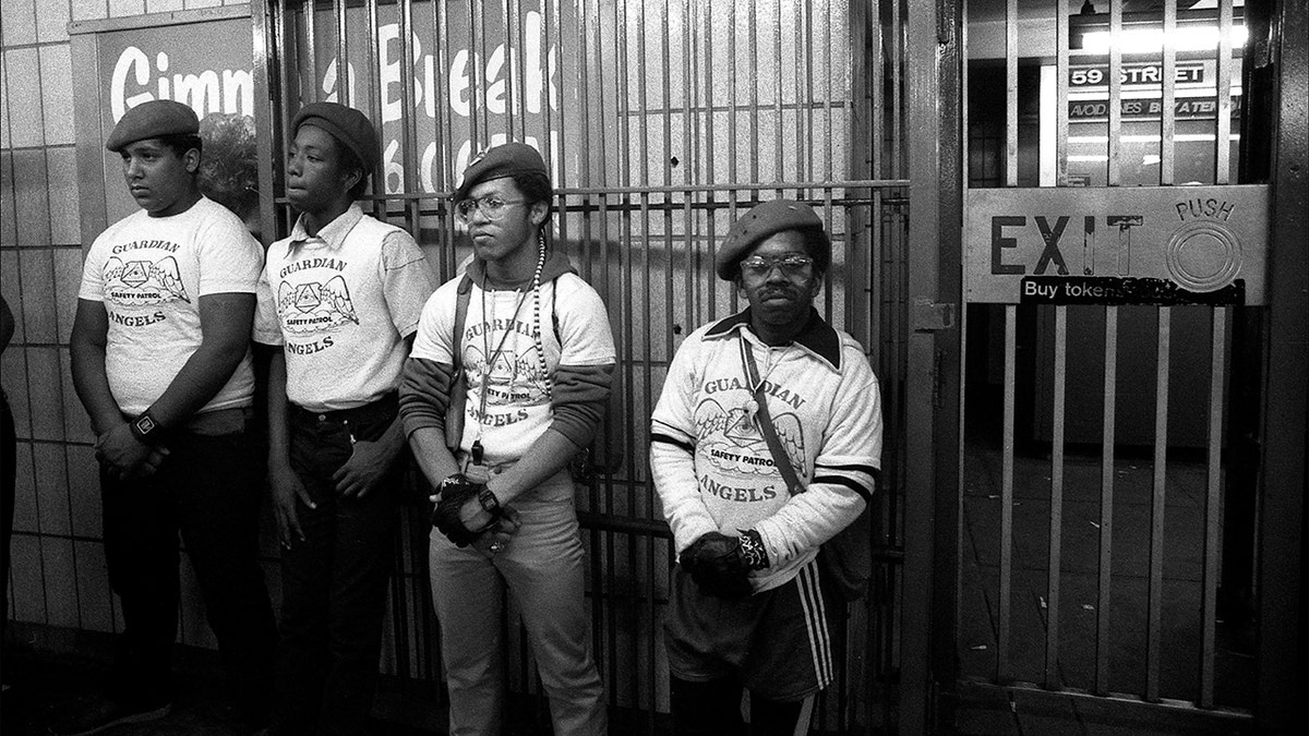 Portait of four members of the Guardian Angels' as they stand in a subway station, New York, New York, mid 1980s.