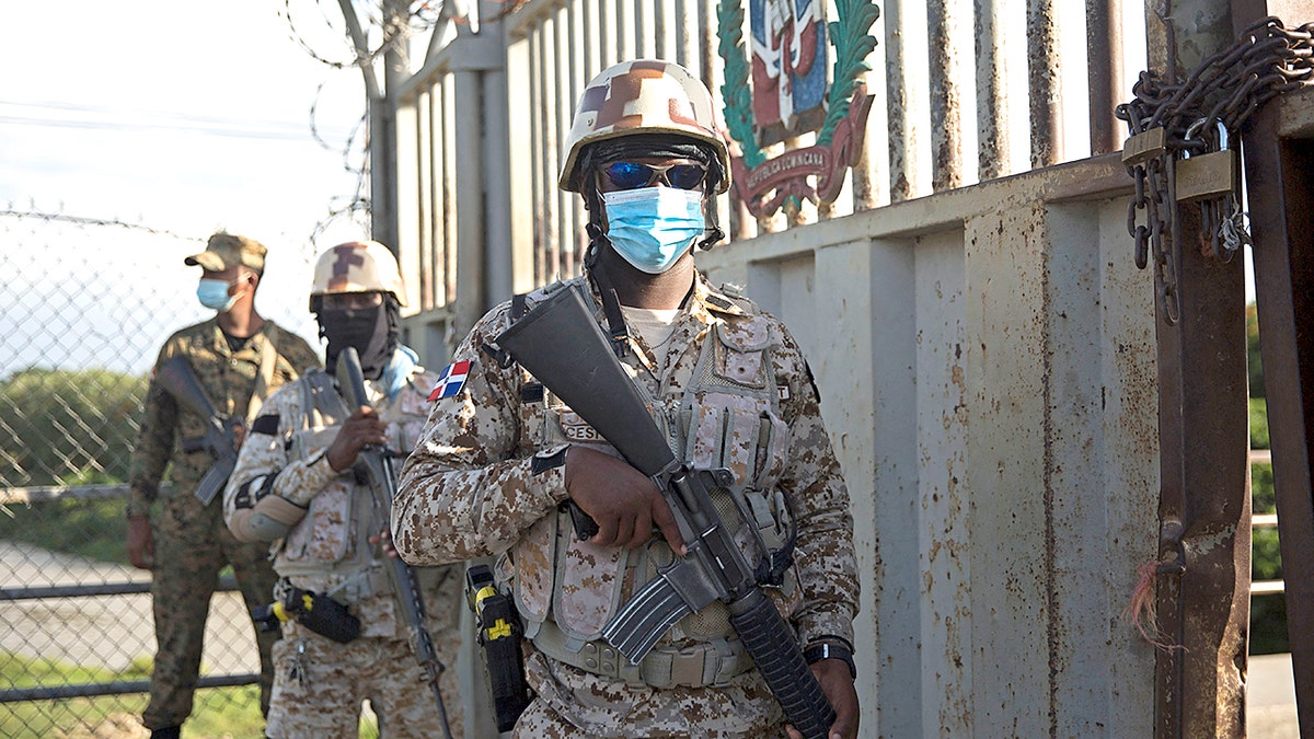 Soldiers guard the Dajabon border crossing between the Dominican Republic and Haiti after the borders were closed due to the assassination perpetrated by an armed group against the president of Haiti, Jovenel Moise, in the early hours of Wednesday, July 7, 2021. - Haiti President Jovenel Moise was assassinated and his wife wounded early July 7, 2021 in an attack at their home, the interim prime minister announced, an act that risks further destabilizing the Caribbean nation beset by gang violence and political volatility. Claude Joseph said he was now in charge of the country and urged the public to remain calm, while insisting the police and army would ensure the population's safety.The capital Port-au-prince as quiet on Wednesday morning with no extra security forces on patrol, witnesses reported. (Photo by Erika SANTELICES / AFP) (Photo by ERIKA SANTELICES/afp/AFP via Getty Images)