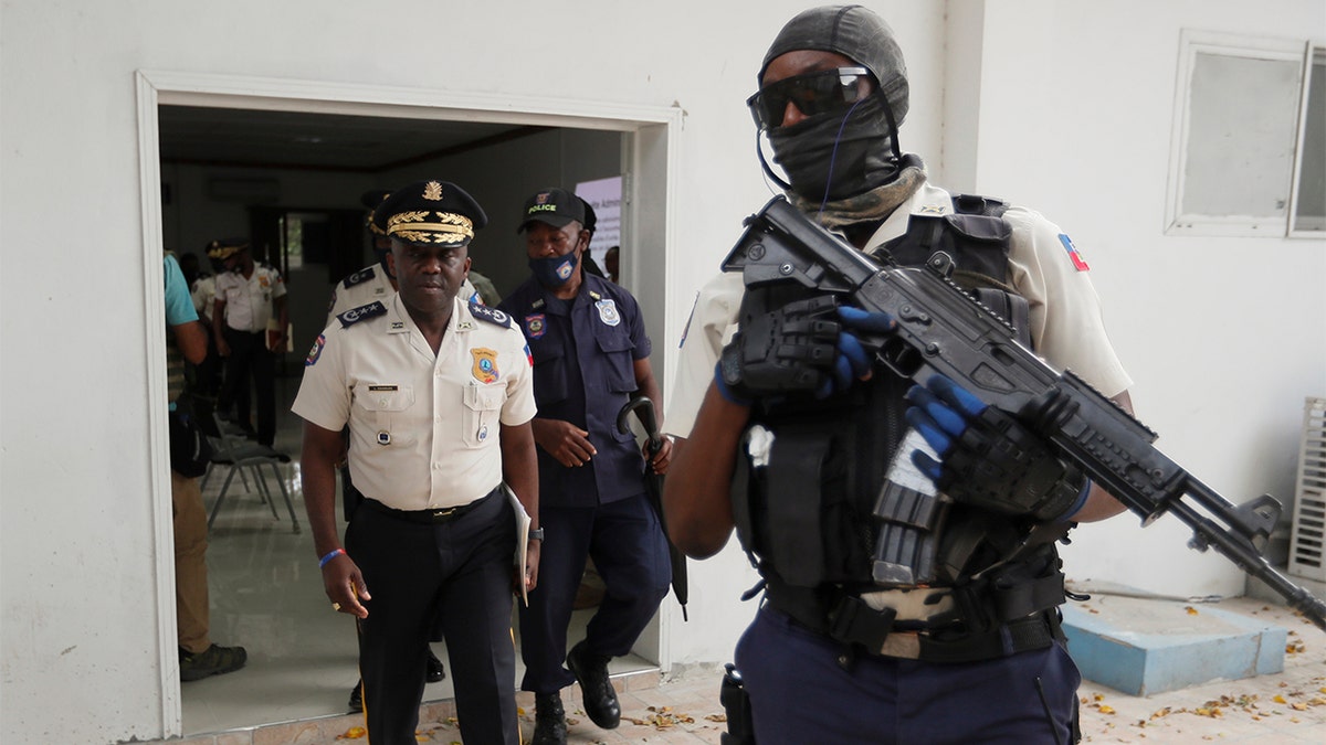 Leon Charles, left, Director General of Haiti's Police leaves a room after a news conference at police headquarters in Port-au-Prince, Wednesday, July 14, 2021. Charles gave an updated on the investigation of the July 7 assassination of President Jovenel Moise. (AP Photo/Fernando Llano)