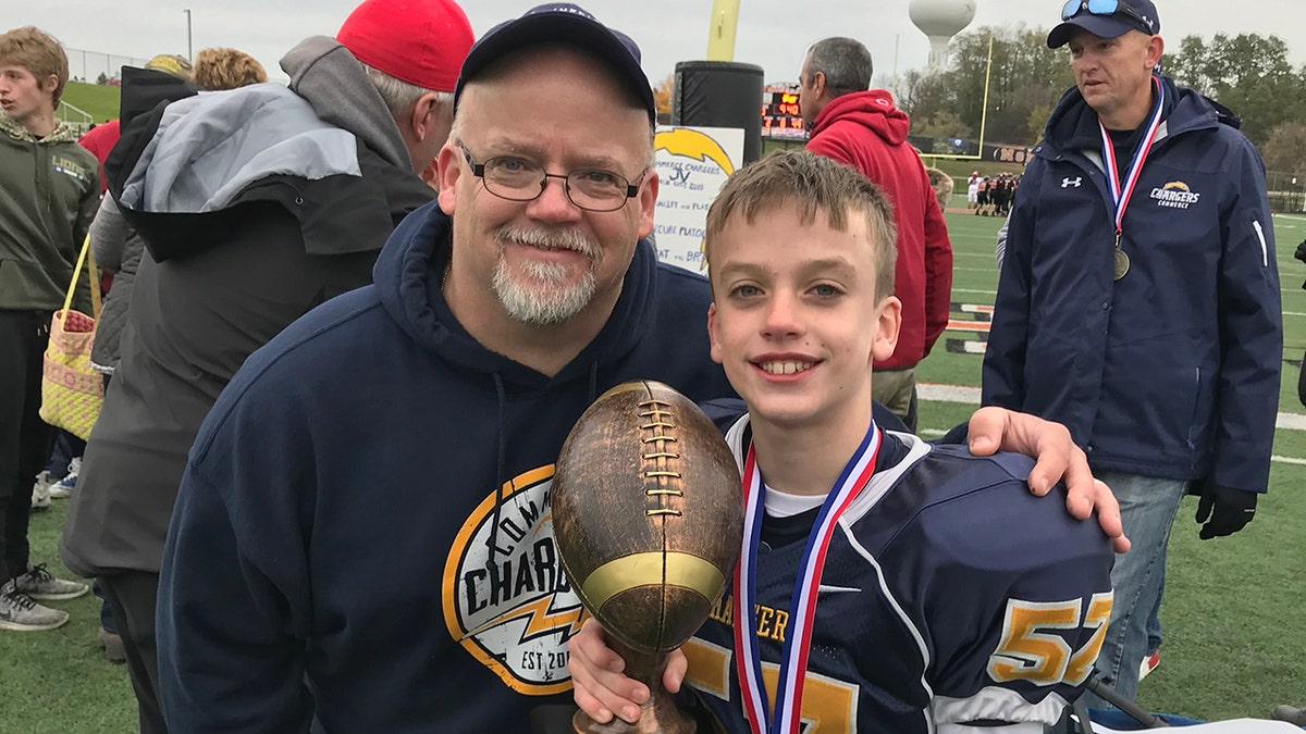 Dave Snook (right) and his 13-year-old son, Andrew "Andy" Snook. Andy was found underwater after going missing for 20 minutes on June 25 in a pond at a Petersberg, Michigan Kampgrounds of America camp. He's in critical condition at Cleveland Clinic Medical Center in Ohio.  