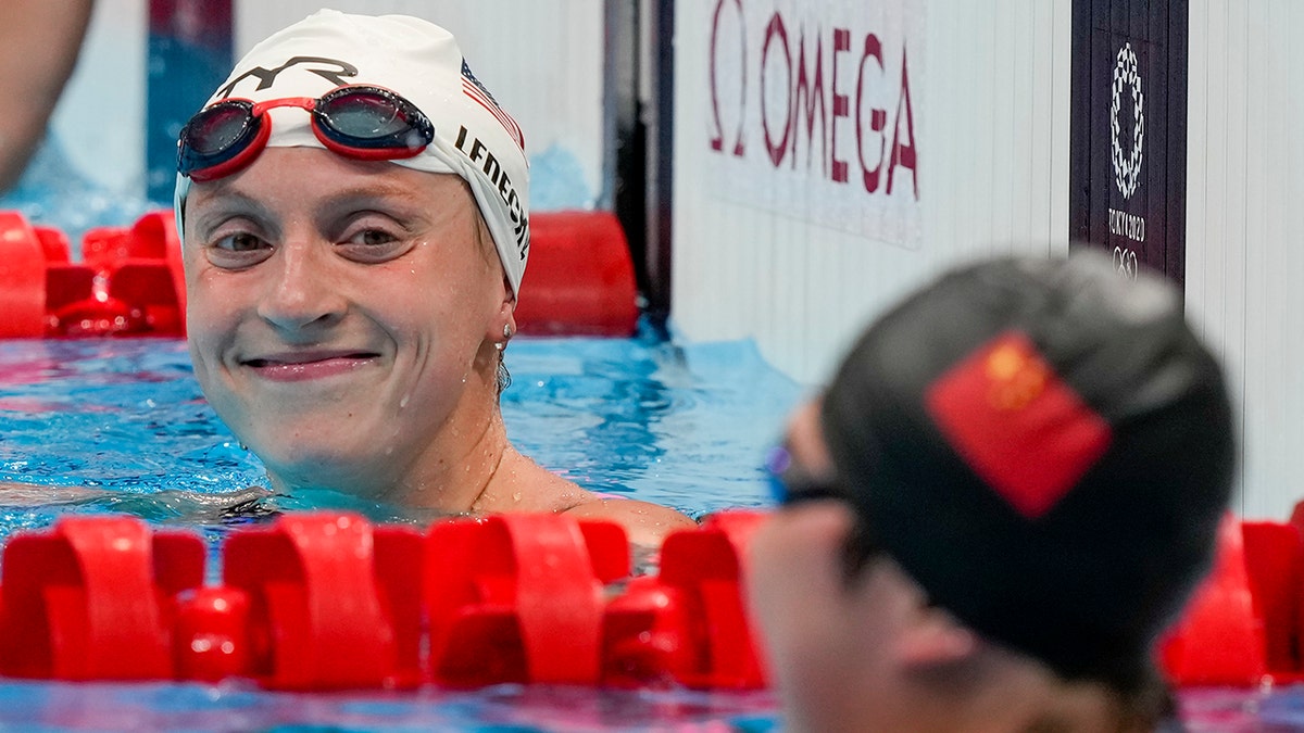 Katie Ledecky, of the United States, reacts following her swim in a heat of the women's 1500-meter freestyle at the 2020 Summer Olympics