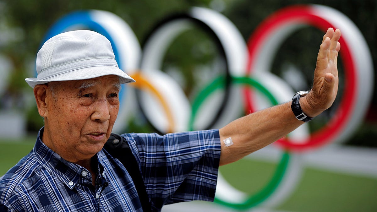 Kohei Jinno, 87, who was forced to leave his house two times ahead of the 1964 and 2020 Olympics Games to make way for construction of the main stadium, speaks in front of the Olympic Rings monument outside the Japan Olympic Museum near the National Stadium, the main stadium for the 2020 Tokyo Olympic Games that have been postponed to 2021 due to the coronavirus disease (COVID-19) pandemic, in Tokyo, Japan June 24, 2021.  Picture taken June 24, 2021.