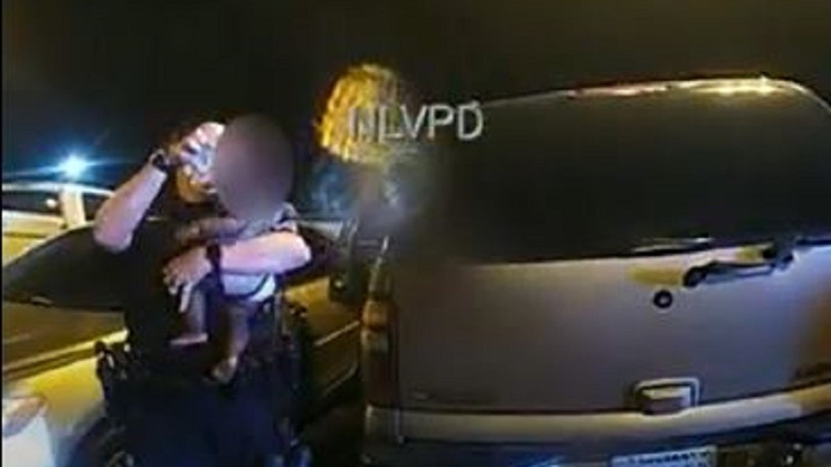 North Las Vegas police Sgt. Becky Salkoff pours water over a crying baby who was left in a hot car. 