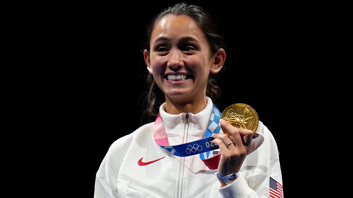 Gold medalist Lee Kiefer of the United States, holds her gold medal during the medal ceremony for the women's individual Foil final competition at the 2020 Summer Olympics