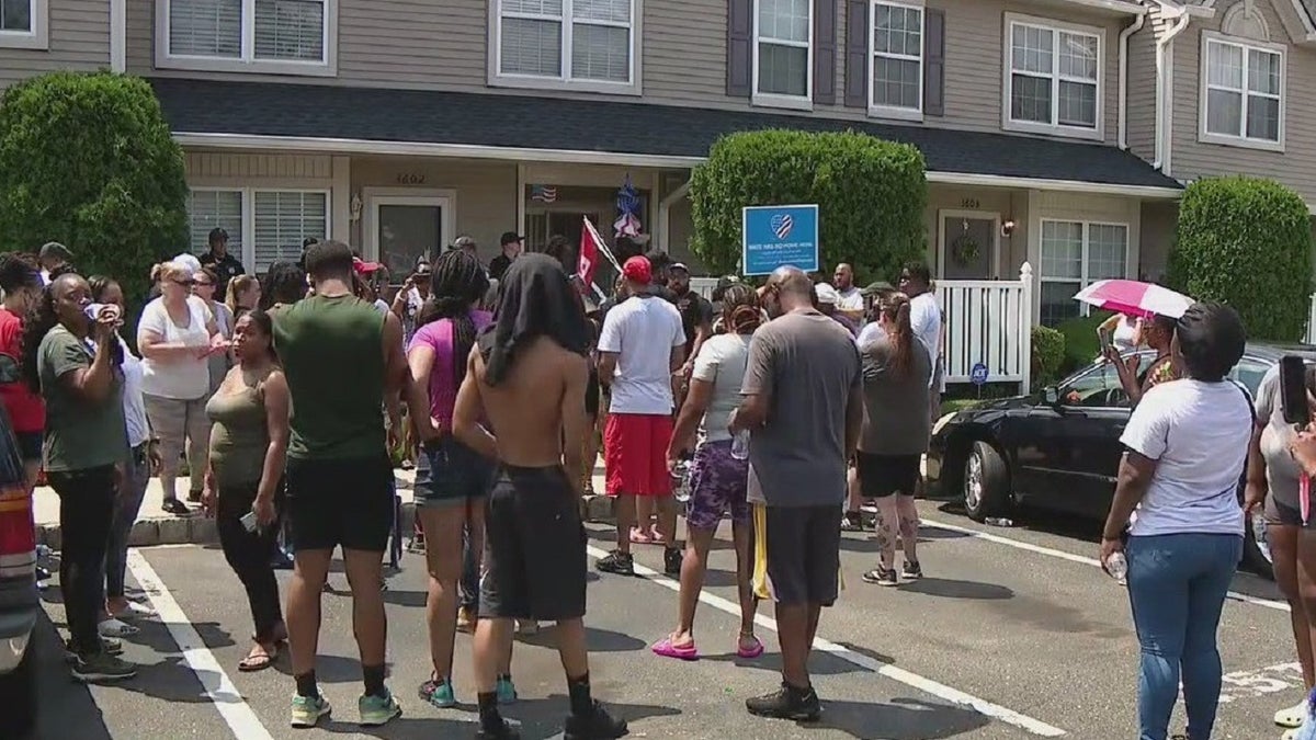 Protesters gathered outside of a home in Mount Laurel, N.J., on Monday.