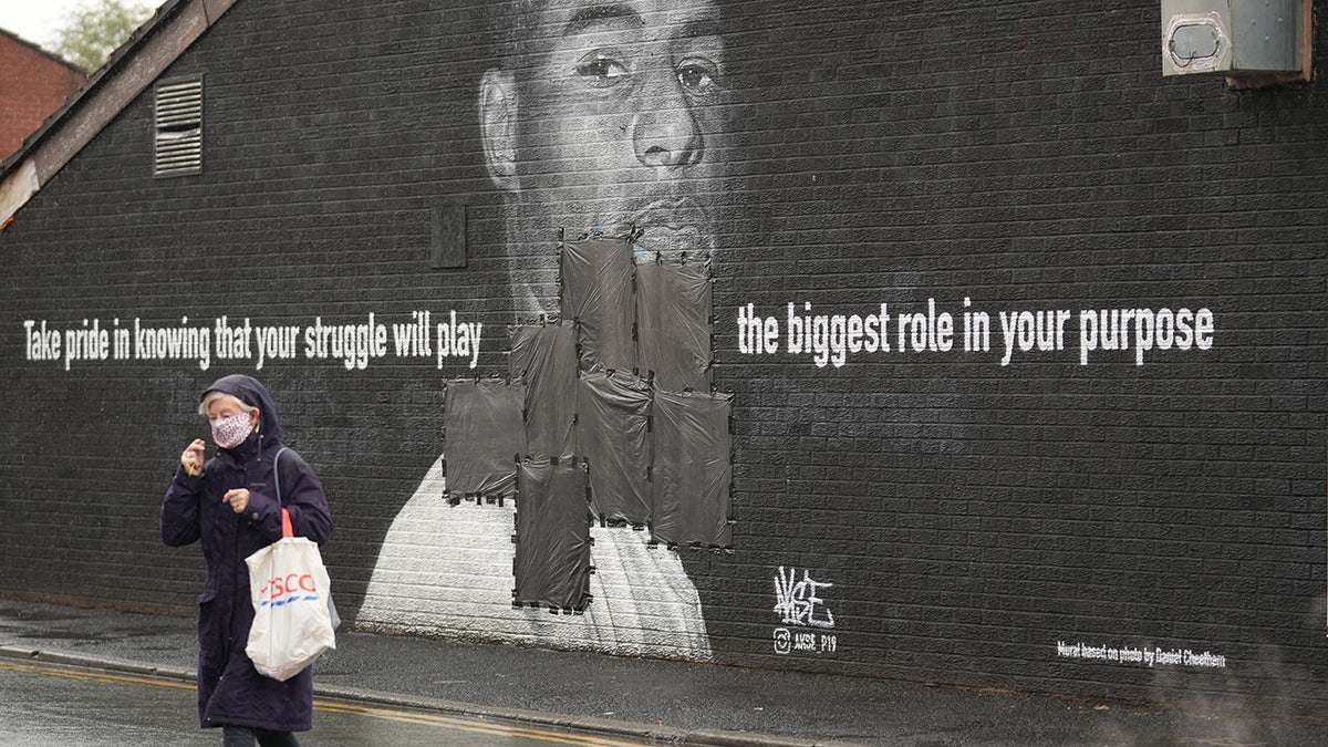 MANCHESTER, ENGLAND - JULY 12: Bin bags cover offensive graffiti on the vandalized mural of Manchester United striker and England player Marcus Rashford on the wall of a cafe in Manchester. (Photo by Christopher Furlong/Getty Images)