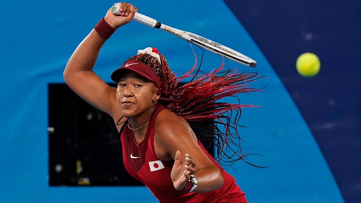 Naomi Osaka, of Japan, plays Marketa Vondrousova, of the Czech Republic, during the third round of the tennis competition at the 2020 Summer Olympics, Tuesday, July 27, 2021, in Tokyo, Japan. (AP Photo/Seth Wenig)