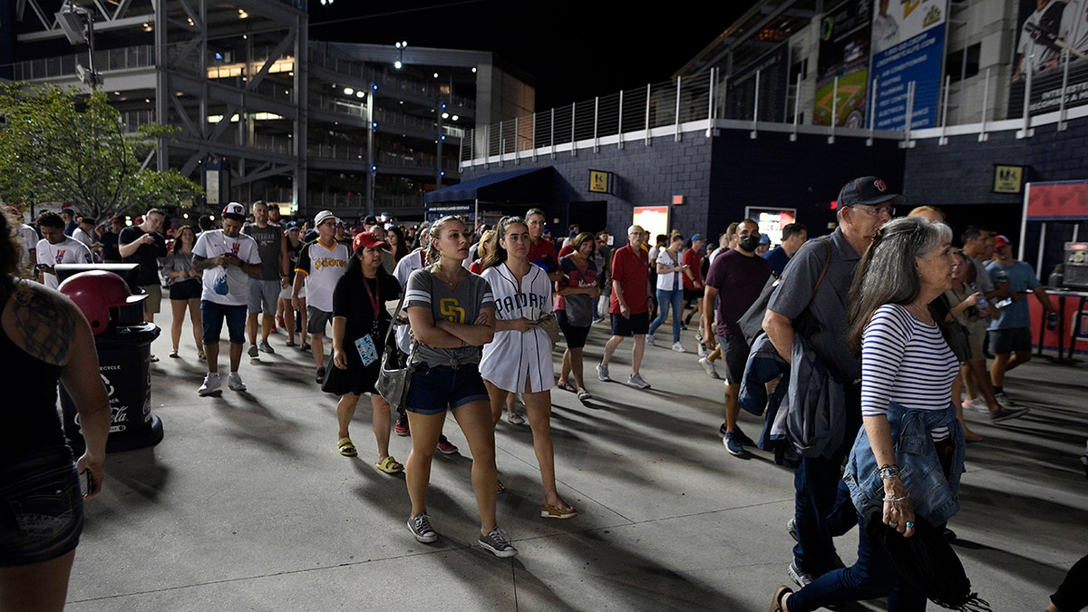 Spectators leave Nationals Park after an incident near the ballpark during the sixth inning of a baseball game between the Washington Nationals and the San Diego Padres, Saturday, July 17, 2021, in Washington. (Associated Press)