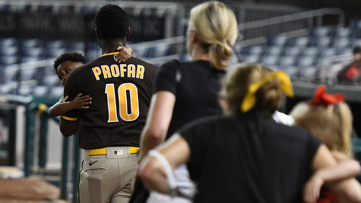 Jurickson Profar of the San Diego Padres is seen comforting a child after Saturday's Nationals-Padres game was suspended following gunfire outside the stadium. (Getty Images)