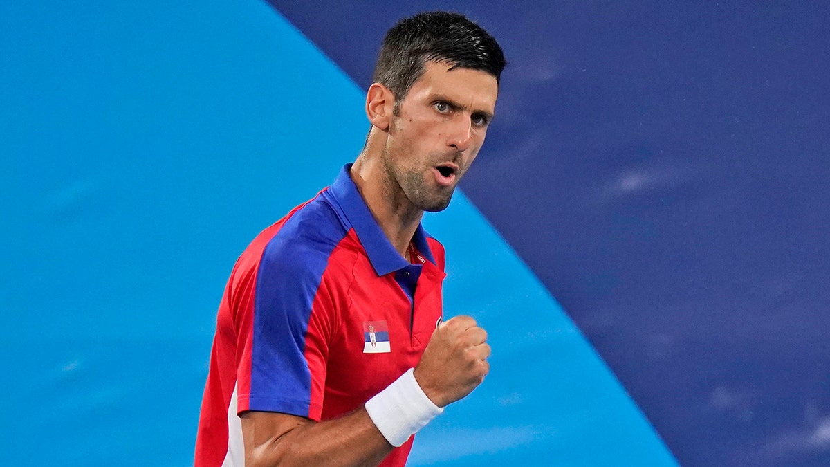 Novak Djokovic, of Serbia, reacts while playing Kei Nishikori, of Japan, during the quarterfinals of the tennis competition at the 2020 Summer Olympics, Thursday, July 29, 2021, in Tokyo, Japan.