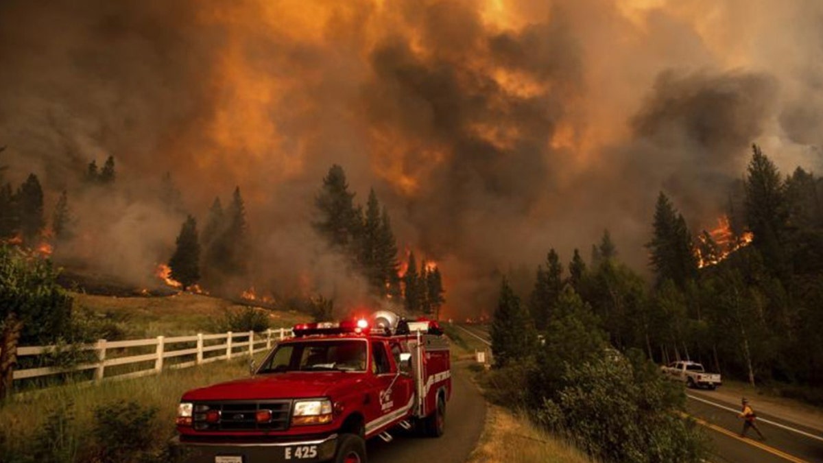 The rapidly growing wildfire jumped a highway, prompting more evacuation orders and the cancellation of an extreme bike ride through the Sierra Nevada.