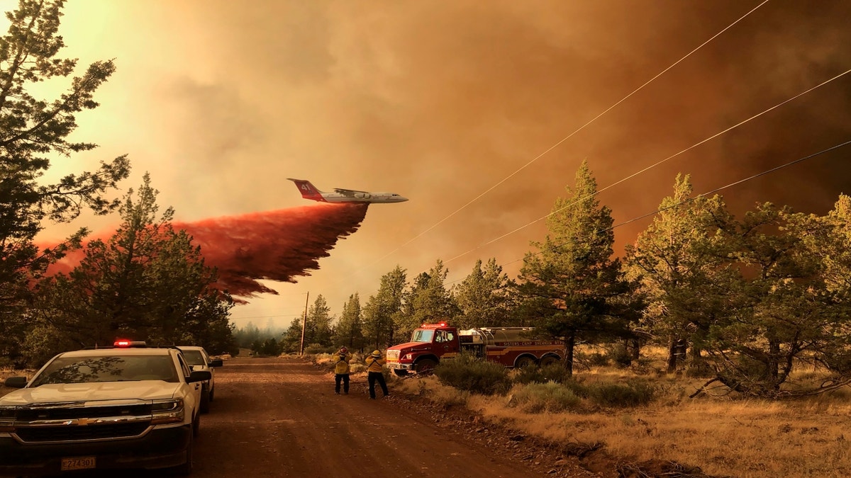 This photo provided by the Oregon Department of Forestry shows a firefighting tanker making a retardant drop over the Grandview Fire near Sisters, Ore., Sunday, July 11, 2021. (Oregon Department of Forestry via AP)