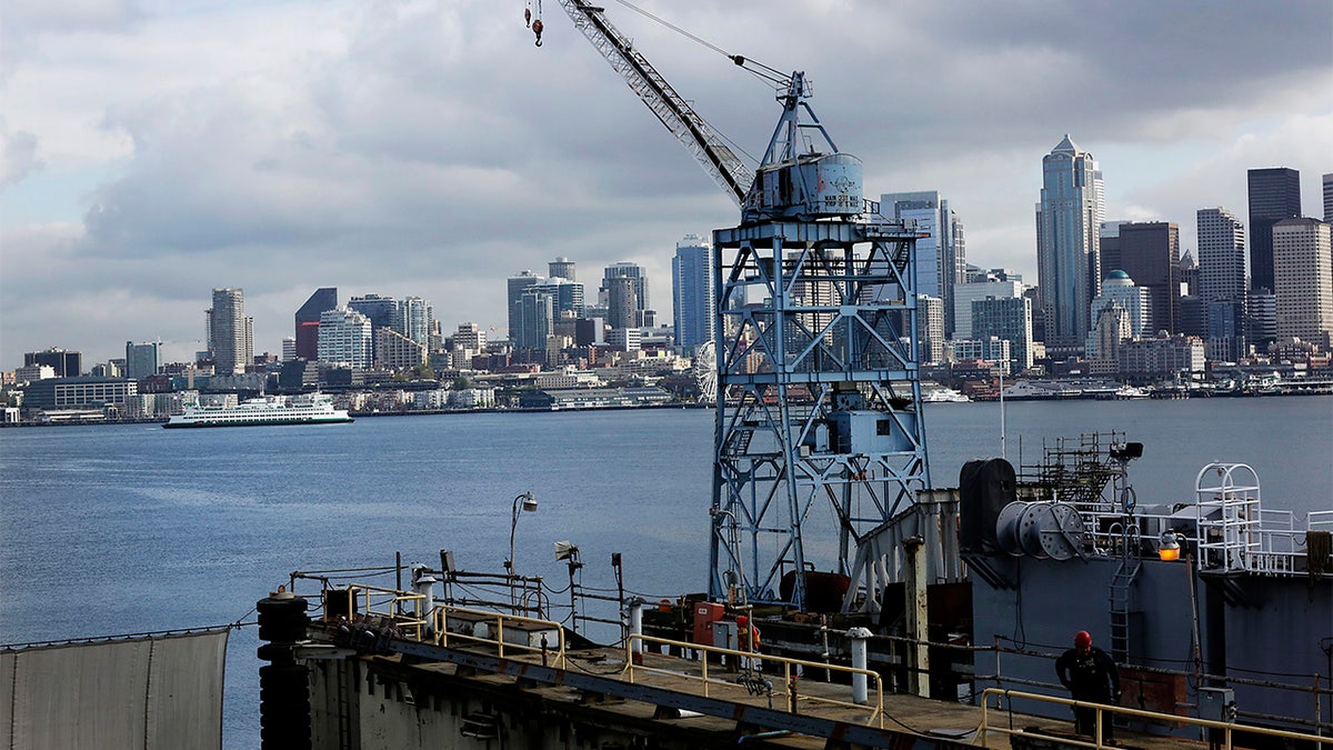 A Washington State Ferry traverses past the city skyline through Puget Sound as seen from the Vigor Shipyard in Seattle, Washington, U.S., on Friday, April 18, 2014. 