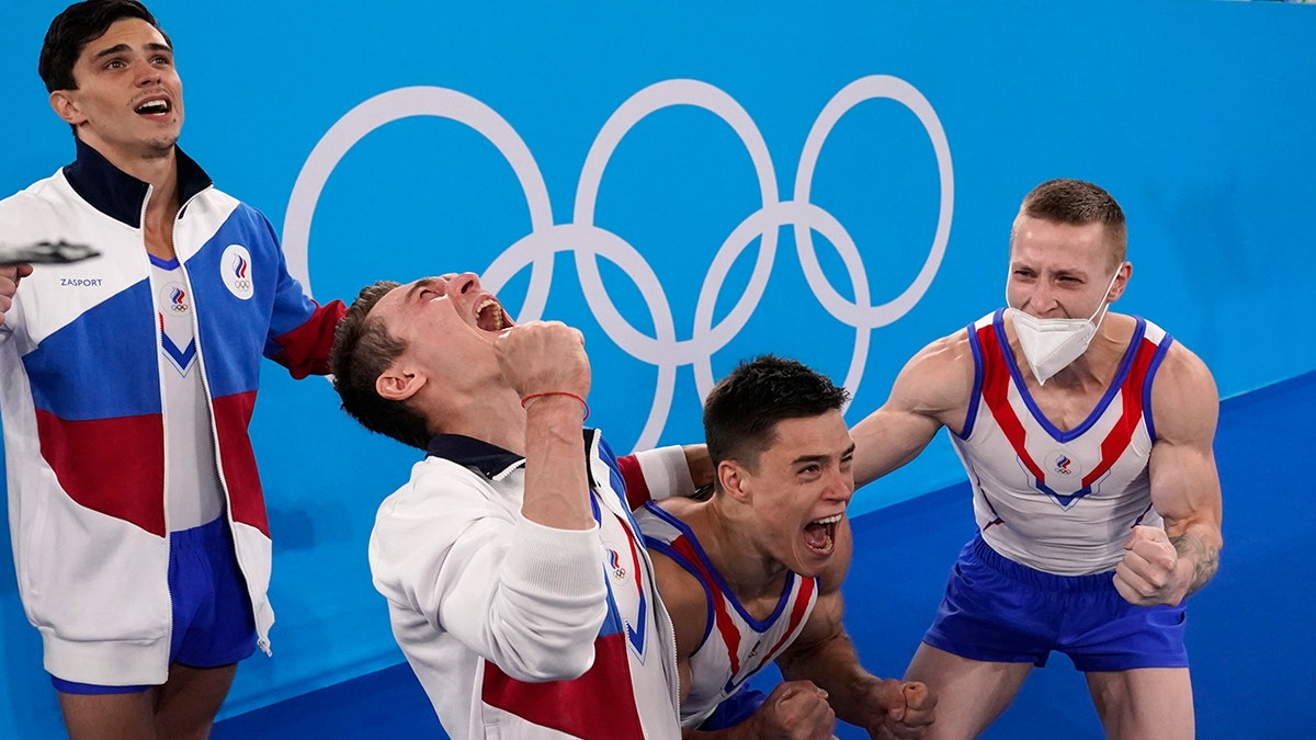 Russian Olympic Committee's artistic gymnastics men's team, from right, Denis Abliazin, right, Nikita Nagornyy, David Belyavskiy and Artur Dalaloyan celebrate after winning the gold medal at the 2020 Summer Olympics, Monday, July 26, 2021, in Tokyo. (AP Photo/Gregory Bull)