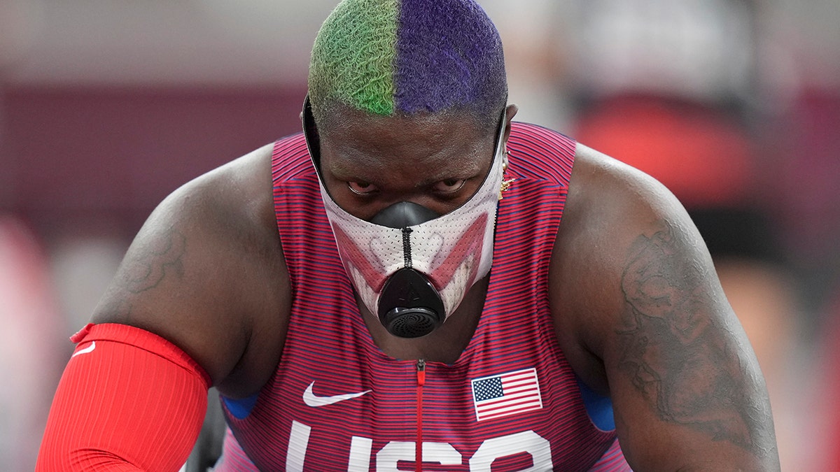 Raven Saunders of the United States rests during throws of the qualification rounds of the women's shot put at the 2020 Summer Olympics, Friday, July 30, 2021, in Tokyo. (AP Photo/Matthias Schrader)
