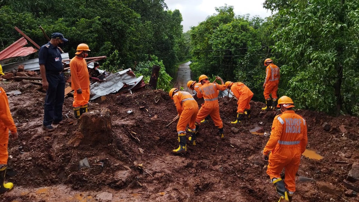 Members of National Disaster Response Force (NDRF) conduct a search and rescue operation after a landslide following heavy rains in Ratnagiri district, Maharashtra state, India, July 25, 2021. National Disaster Response Force/Handout via REUTERS
