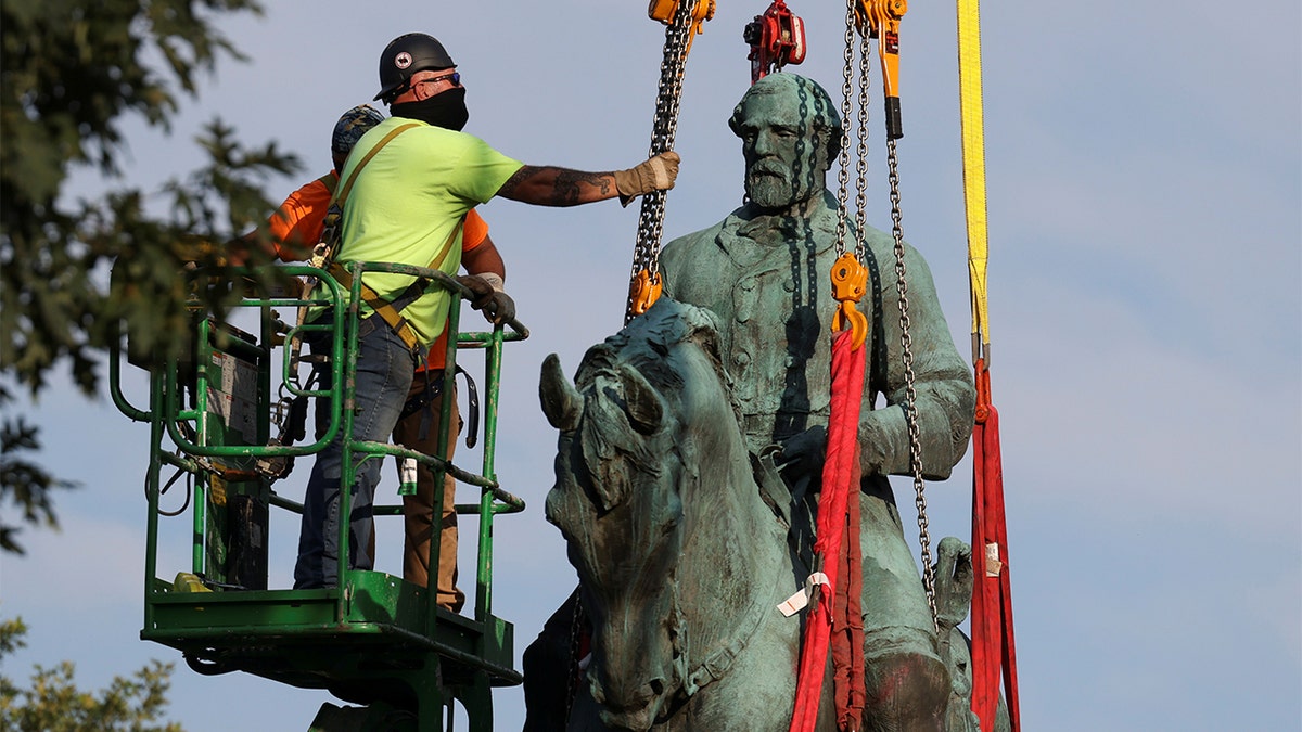 Workers remove a statue of Confederate General Robert E. Lee, after years of a legal battle over the contentious monument, in Charlottesville, Virginia, the U.S, July 10, 2021. 