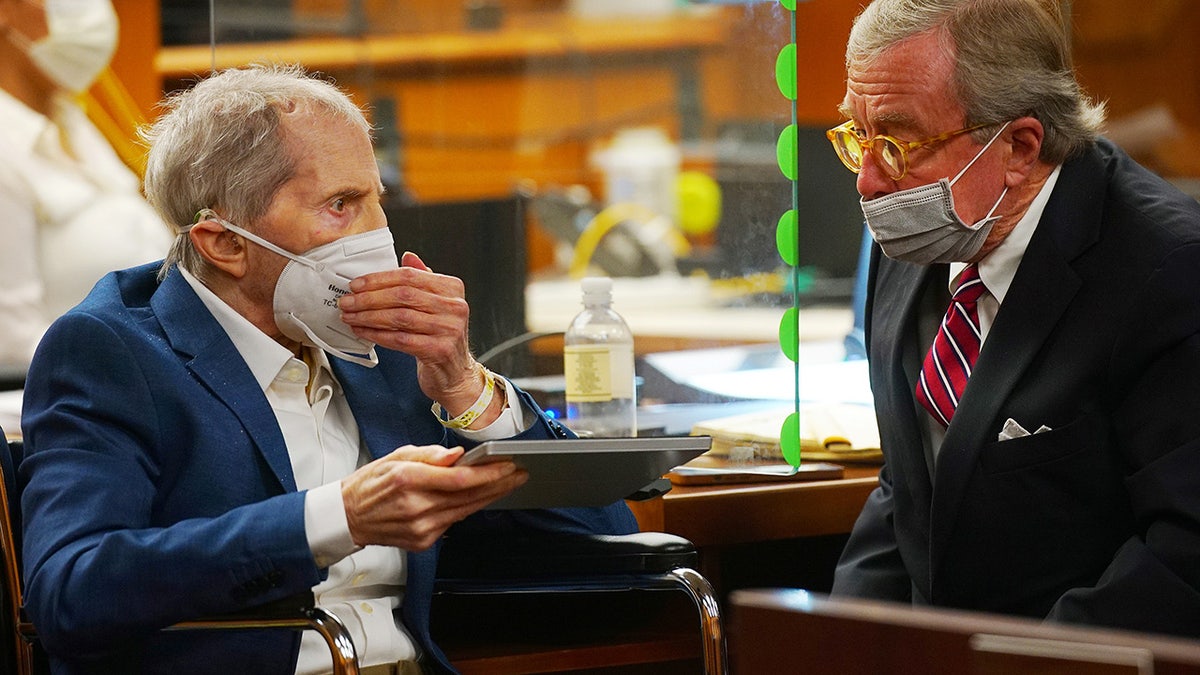 Defendant Robert Durst is assisted by his attorney Dick DeGuerin in an Inglewood courtroom as Judge Mark E. Windham (not shown) gives instructions before opening statements in the trial of the real estate scion charged with murder of longtime friend Susan Berman, in Inglewood, Calif, May 18, 2021. (Al Seib/Pool via REUTERS)