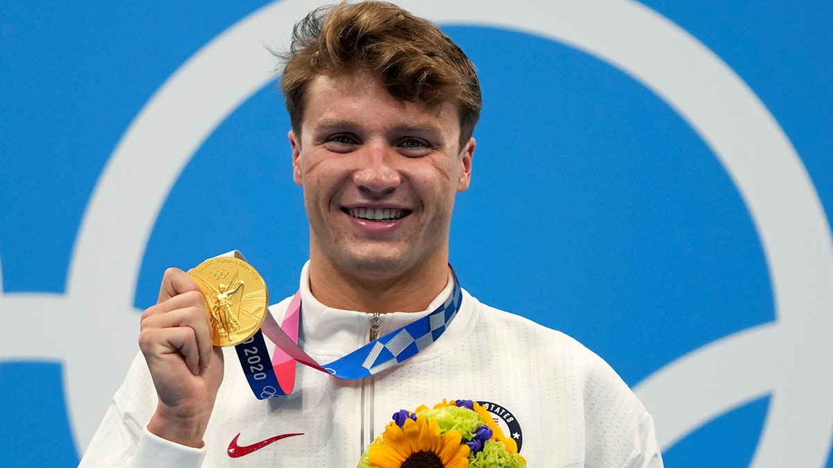 Robert Finke of the United States poses with his gold medal for the men's 800-meters freestyle final at the 2020 Summer Olympics