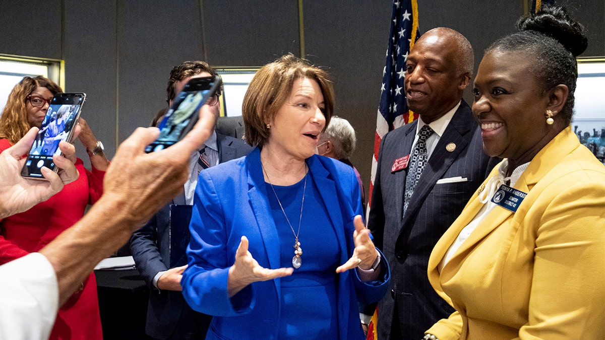 Sen. Amy Klobuchar, center, D-Minn., talks with Georgia State Legislators following a Senate Rules Committee field hearing on voting rights at the National Center for Civil and Human Rights in Atlanta, Monday, July 19, 2021. (AP Photo/Ben Gray)