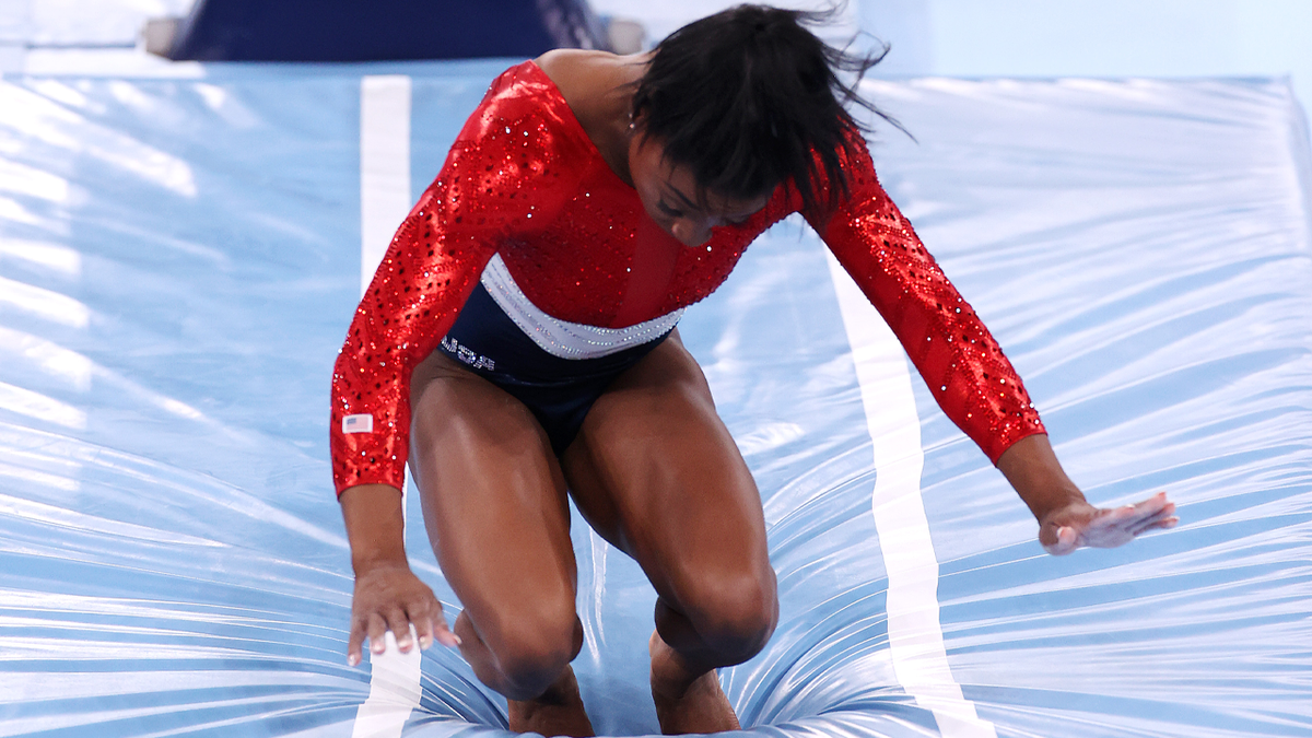 Simone Biles of Team United States stumbles upon landing after competing in vault during the Women's Team Final on day four of the Tokyo 2020 Olympic Games at Ariake Gymnastics Centre on July 27, 2021 in Tokyo, Japan. 