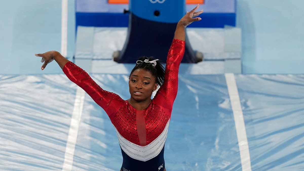 Simone Biles, of the United States, dismounts from the vault during the artistic gymnastics women's final at the 2020 Summer Olympics, Tuesday, July 27, 2021, in Tokyo. (AP Photo/Natacha Pisarenko)