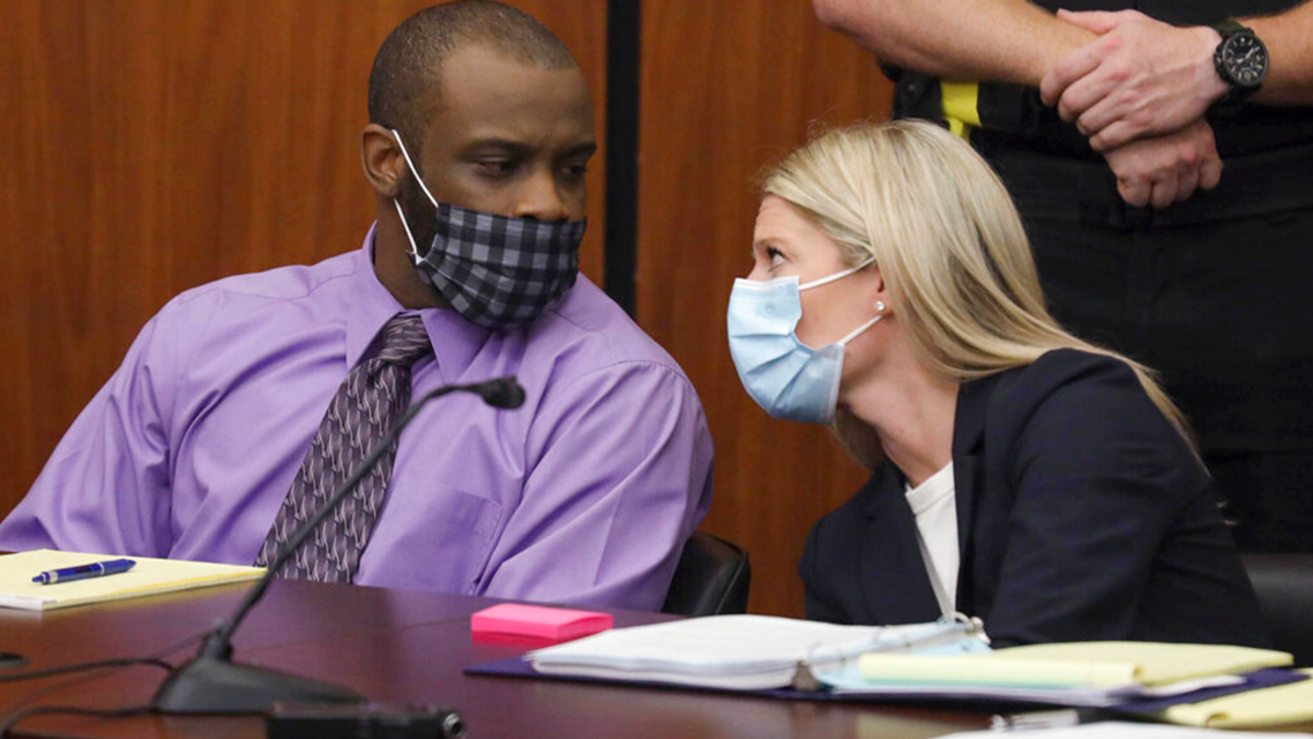 Defendant Nathaniel Rowland speaks with his attorney, Alicia Goode, right, during his trial in Richland County Court, Tuesday, July 20, 2021, in Columbia, S.C. 