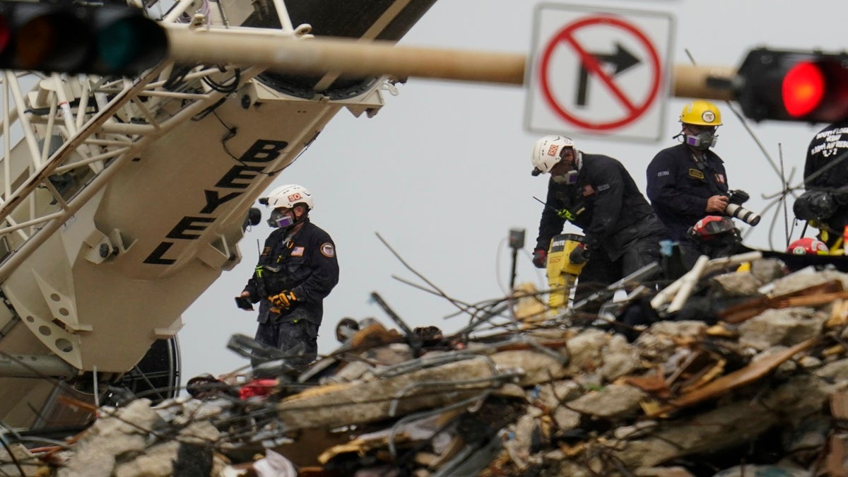 Search and rescue personnel work atop the rubble at the Champlain Towers South condo building on Wednesday. (AP)