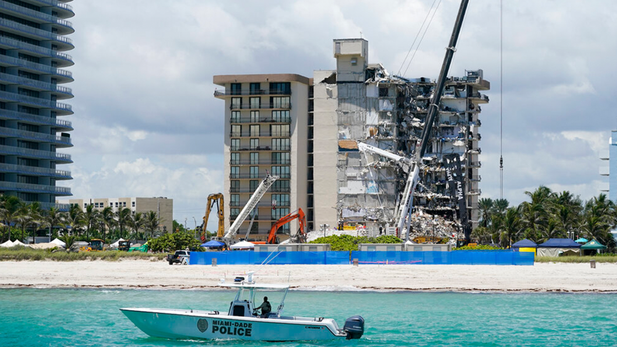 A Miami-Dade County Police boat patrols in front of the Champlain Towers South condo building, where search and rescue efforts continue more than a week after the building partially collapsed, Friday, July 2, 2021, in Surfside, Fla.