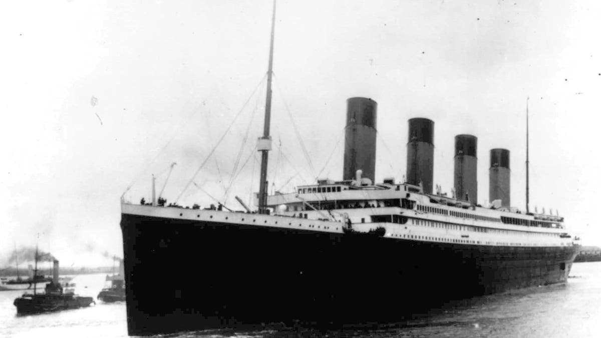 The RMS Titanic leaves England in a black and white photo