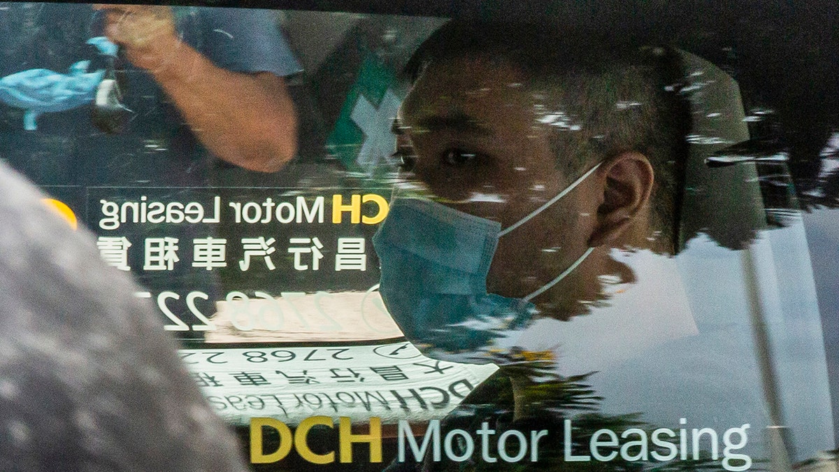 Tong Ying-kit, who is accused of deliberately driving his motorcycle into a group of police officers on July 1, arrives at the West Kowloon court in Hong Kong on July 6, 2020. - Tong, 23, charged with inciting secession and one charge of terrorism, became the first person in Hong Kong on July 3 to be charged under Beijing's sweeping new national security law. (Photo by ISAAC LAWRENCE / AFP) (Photo by ISAAC LAWRENCE/AFP via Getty Images)